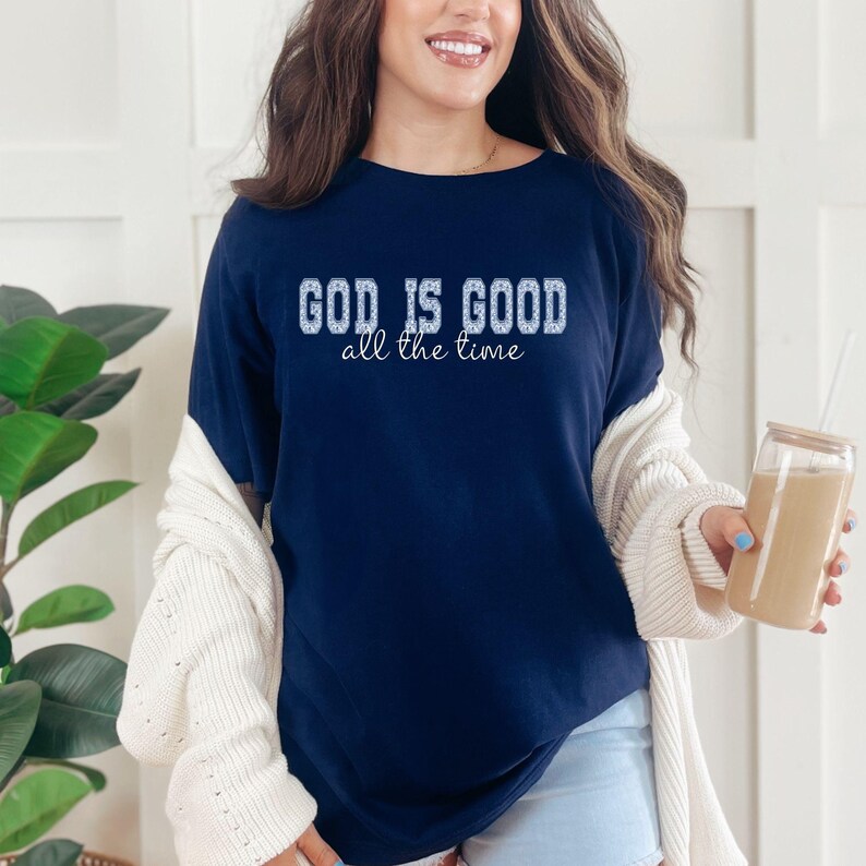 Navy blue Christian graphic tee “God is good all the time” styled with cardigan and coffee, cozy casual outfit, faith based clothing for women