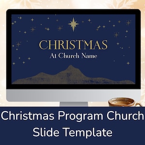 May include: A computer monitor displays a Christmas-themed slide template. The screen shows a dark blue background with gold stars, a star, and the word "CHRISTMAS" in gold. Below the text is a mountain range graphic. A coffee cup sits below the monitor.