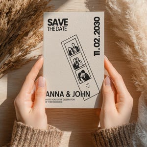 A beige Save the Date card held by hands, featuring black text and a photo strip with three images. The card reads "SAVE THE DATE," "ANNA & JOHN," and "11.02.2030." The card also includes the text "invites you to the celebration of their marriage."