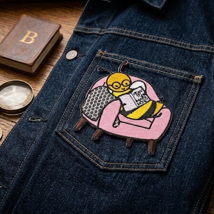 May include: A set of three ceramic mugs with a speckled, matte finish. The mugs are in shades of cream, light brown, and dark brown. Each mug has a simple, minimalist design and a rounded handle.