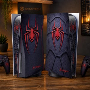 May include: Two gaming console faceplates and two matching controllers featuring a dark blue and black textured pattern with a prominent red spider emblem and the text Be Yourself printed in red at the bottom of each console side panel.