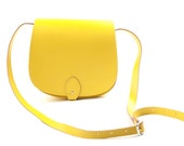 Small bright yellow genuine leather saddle bag with buckle flap closure