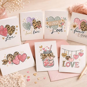 May include: A collection of greeting cards with heart designs. The cards feature various heart illustrations, including leopard print, floral accents, and the word "Love" in different fonts. Some cards have the phrases "Sweet Love" and "forever love".