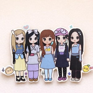 May include: A sticker sheet featuring five cartoon girls with large eyes and various outfits. The girls have different hairstyles and wear dresses, skirts, and tops in pastel colours. The sticker sheet includes small decorative elements.