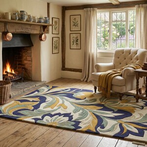 May include: A large area rug with a floral design in blue, yellow, and green hues. The rug is placed in a cozy living room setting with a fireplace, armchair, and wooden flooring. The room has a warm and inviting atmosphere.