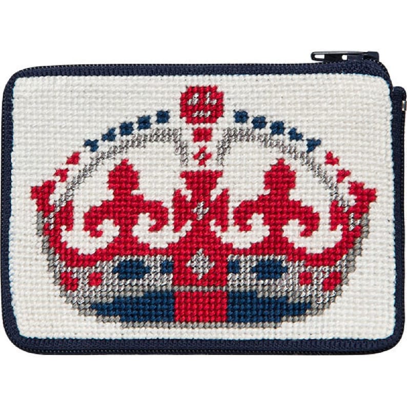 May include: A white needlepoint zippered pouch with a red, white, and blue embroidered crown design.