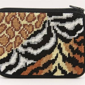 May include: A small zippered pouch with a black background and a colorful animal print design. The print features a zebra, leopard, and tiger pattern.