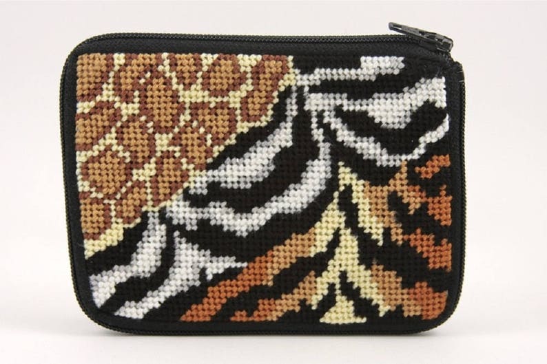 May include: A small zippered pouch with a black background and a colorful animal print design. The print features a zebra, leopard, and tiger pattern.