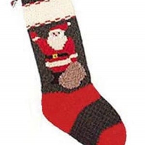 May include: A knitted Christmas stocking with a Santa Claus design. The stocking is brown and red with white accents. Santa is holding a bag of gifts.