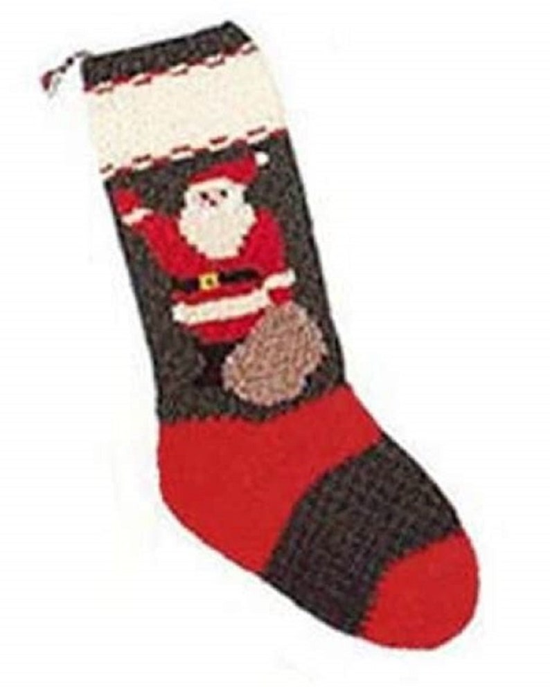 May include: A knitted Christmas stocking with a Santa Claus design. The stocking is brown and red with white accents. Santa is holding a bag of gifts.