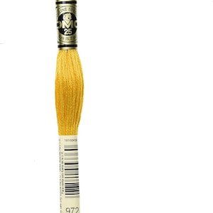 May include: A skein of DMC 25 embroidery floss in a vibrant yellow color, labeled with the number 972. The label indicates 8 meters (8.7 yards) of thread. Ideal for cross-stitch, embroidery, and other needlecraft projects.