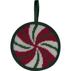 May include: A round Christmas ornament with a spiral design in red, white, and green. The ornament has a dark green border and a matching ribbon for hanging. The design resembles a peppermint candy.