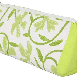May include: A triangular pencil case with a white background and a repeating pattern of green floral designs. The ends of the case are solid lime green, and it has a silver zipper.