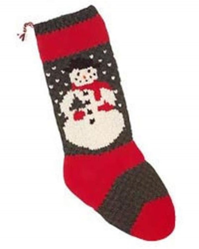 May include: A red and gray knitted Christmas stocking with a snowman design. The snowman is wearing a red scarf and hat.