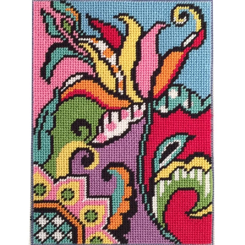 Pode incluir: Um desenho de ponto de agulha colorido com um motivo floral estilizado em cores rosa, verde, amarelo, laranja, vermelho, roxo e azul.