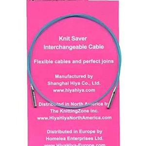 May include: A blue knitting cable with metal ends, labeled "Knit Saver Interchangeable Cable". The cable is flexible and has perfect joins. The packaging is pink and includes the brand name "HiyaHiya" and information about the manufacturer and distributors.