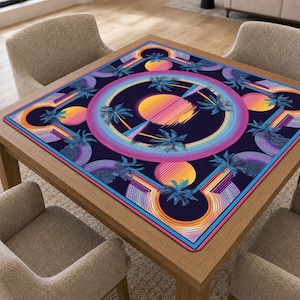 May include: A square table mat featuring a dark blue background with a vibrant retro-style graphic. The design includes multiple yellow and orange suns, concentric neon-coloured circular rings, and silhouettes of palm trees in shades of blue.