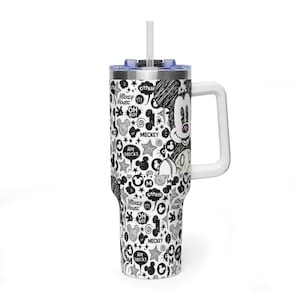 May include: A stainless steel tumbler with a white handle, a clear lid, and a straw. The exterior features a black and white sketch-style pattern of Mickey Mouse faces, stars, swirls, and speech bubbles with text including Mickey Mouse and Oh Boy.