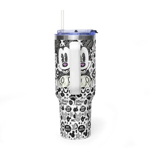 May include: A stainless steel tumbler with a handle, a clear lid, and a straw. The exterior features a black and white sketch-style pattern of Mickey Mouse faces, stars, and text including "Oh Boy," "Mickey Mouse," and "Aw Shucks" with pink heart accents.