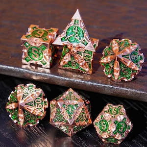 May include: Set of six metallic dice in various geometric shapes. The dice have a copper-colored finish with green enamel detailing. Each die features numbers and intricate designs, suitable for tabletop gaming.