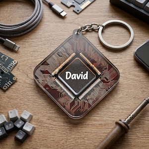 May include: A square, transparent keychain featuring a printed circuit board pattern in shades of brown and copper. The center of the design displays the name David in white text. The keychain includes a silver metal ring and chain attachment.