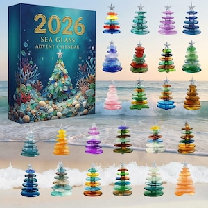 May include: A 2026 Sea Glass Advent Calendar box featuring a coral reef and sea glass Christmas tree illustration, accompanied by twenty-four individual miniature Christmas tree ornaments crafted from stacked, multi-colored sea glass pieces.