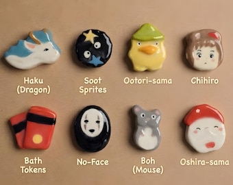 May include: Eight small ceramic figures arranged in two rows. Top row: Haku (Dragon), Soot Sprites, Ootori-sama, Chihiro. Bottom row: Bath Tokens, No-Face, Boh (Mouse), Oshira-sama. Each piece features a glossy finish and distinct character designs.