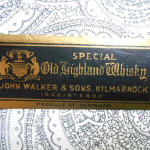 May include: A gold label with black text reads "SPECIAL Old Highland Whisky JOHN WALKER & SONS. KILMARNOCK REGISTERED PRODUCE OF SCOTLAND". The label features a crest with two gold lions and the words "GOLD LABEL" in gold.