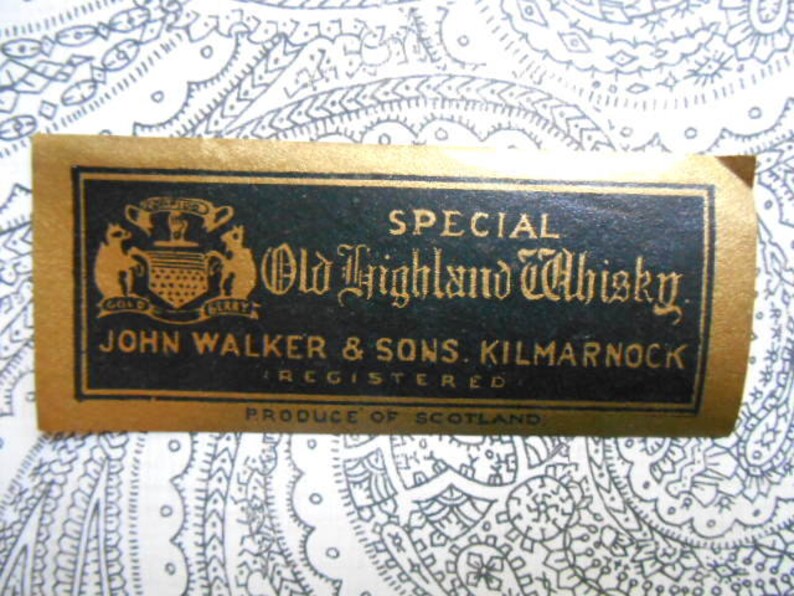 May include: A gold label with black text reads "SPECIAL Old Highland Whisky JOHN WALKER & SONS. KILMARNOCK REGISTERED PRODUCE OF SCOTLAND". The label features a crest with two gold lions and the words "GOLD LABEL" in gold.