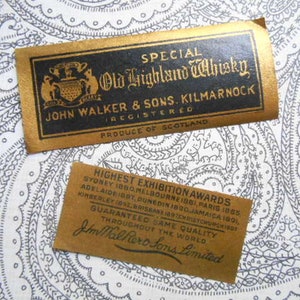May include: A gold label with black text reads "Special Old Highland Whisky. John Walker & Sons. Kilmarnock Registered. Produce of Scotland." Below the label is a smaller brown label with black text that reads "Highest Exhibition Awards Sydney 1880, Melbourne 1881, Paris 1885, Adelaide 1890, Dunedin 1890, Jamaica 1891, Kimberley 1892, Brisbane 1897, Christchurch 1907. Guaranteed Same Quality Throughout the World. Jm Walker & Sons Limited."