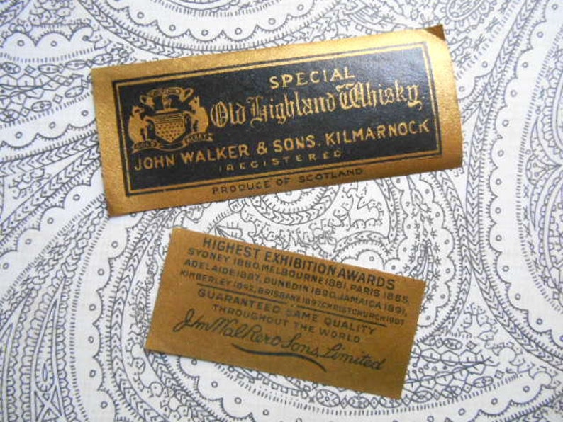 May include: A gold label with black text reads "Special Old Highland Whisky. John Walker & Sons. Kilmarnock Registered. Produce of Scotland." Below the label is a smaller brown label with black text that reads "Highest Exhibition Awards Sydney 1880, Melbourne 1881, Paris 1885, Adelaide 1890, Dunedin 1890, Jamaica 1891, Kimberley 1892, Brisbane 1897, Christchurch 1907. Guaranteed Same Quality Throughout the World. Jm Walker & Sons Limited."