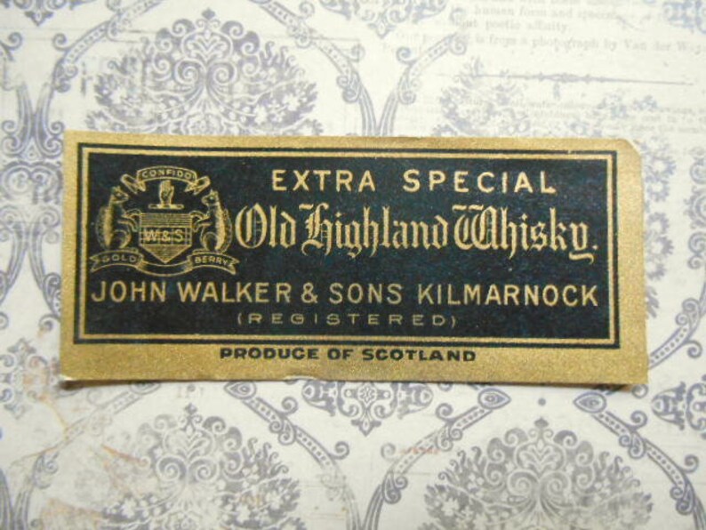 May include: A gold label with black text that reads "EXTRA SPECIAL Old Highland Whisky. JOHN WALKER & SONS KILMARNOCK (REGISTERED) PRODUCE OF SCOTLAND". The label features a crest with the words "CONFIDO GOLD W&S BERRY" and a stag.