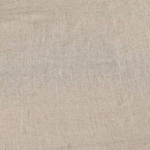 May include: Close-up of a beige linen fabric. The fabric has a textured surface with visible vertical and horizontal threads, creating a subtle grid pattern. The color is a neutral, light tan, suitable for various textile applications.