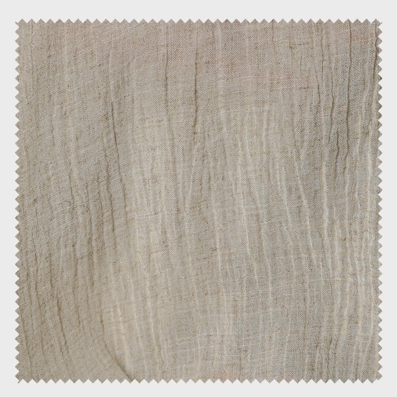 May include: A square swatch of beige linen fabric with a textured, wrinkled appearance. The fabric has a raw, natural look with vertical lines and a jagged edge, suggesting it's cut from a larger piece.