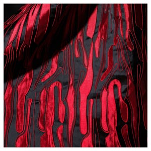 May include: A close-up of a fabric with a striking pattern. The fabric is primarily black, with vibrant red, flame-like shapes embroidered across its surface. The shapes are vertical and have a textured appearance, creating a dynamic visual effect.
