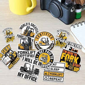 May include: A collection of colorful stickers featuring forklift designs and humorous text. The stickers include phrases like "Forklift Certified," "I'm Here to Fork Stuff Up," and "My Office." The stickers are in various shapes and sizes, with yellow and black color schemes.