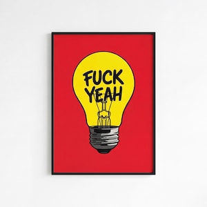 May include: Framed art print featuring a yellow lightbulb with the words "FUCK YEAH" in black. The lightbulb is set against a red background. The print is in a black frame.