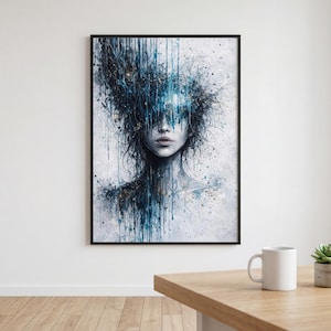 May include: A framed art print featuring a watercolor portrait of a person with blue and white paint strokes. The artwork has a dark background with a focus on the face and upper body. The image is displayed on a white wall.