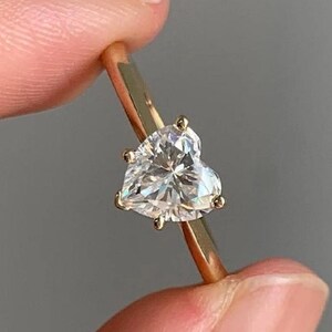 May include: A set of three ceramic mugs with a speckled, matte finish. The mugs are in shades of cream, light gray, and dark gray. Each mug has a simple, minimalist design, perfect for coffee or tea.