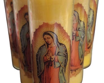 May include: Six yellow glass candles with a religious image of a woman in a blue and red robe. The candles have a white wick and are in a clear glass container. The image is of a woman with her hands clasped in prayer.