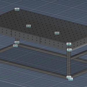 May include: A dark gray rectangular table with a perforated surface and a rectangular frame base. The table appears to be made of metal and is designed for industrial use. The table's dimensions are approximately 48 inches long and 24 inches wide.