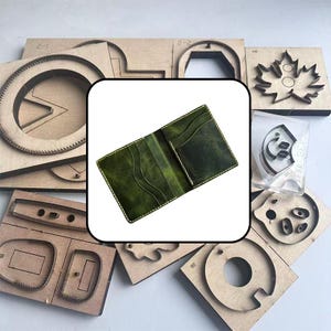 May include: A bi-fold wallet in a deep olive green leather with visible grain and light-colored stitching. The interior features multiple card slots with curved edges, showcasing a structured design for organizing cards and currency.