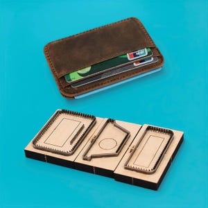 May include: A brown leather wallet with visible credit cards and a set of leathercraft cutting dies. The dies are made of metal and wood, featuring various shapes for crafting leather goods. The background is a solid teal color.