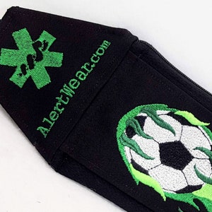 Black Alert Wear Medicine Case with Soccer Ball and Green Flames. Green Medical Alert Symbols on sides.