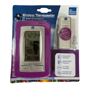 May include: A wireless thermometer by La Crosse Technology. The purple-framed display shows the time, indoor and outdoor temperatures, and a weather girl icon. Includes a remote sensor and a detachable stand. The Weather Channel brand is visible.