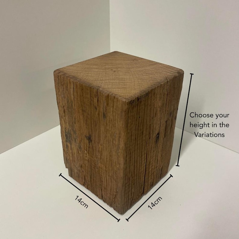 May include: A square wooden block with a natural brown finish and visible grain texture. The block measures 14cm by 14cm at the base, with a vertical dimension that varies. Text on the image reads: Choose your height in the Variations.