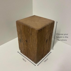 May include: A square wooden block with a natural brown finish and visible grain texture. The block measures 14cm by 14cm at the base, with a vertical dimension that varies. Text on the image reads: Choose your height in the Variations.