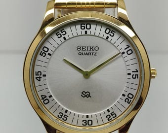 Vintage Seiko slanke tankstijl quartz herenpolshorloge ronde kast zilveren wijzerplaat