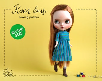 May include: A sewing pattern for a striped dress for a Blythe doll. The pattern is called "Karin dress" and is for Blythe size dolls. The doll is wearing the dress and has long red hair.