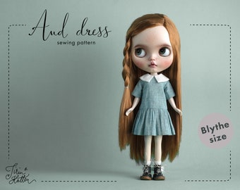 May include: A blue and white dress sewing pattern for a Blythe doll. The pattern is called "And dress" and is designed by "Tirin & Hatter".
